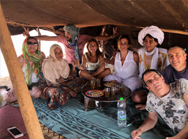 group of travelers in desert nomad tent