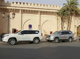 cars unikmaroctours parked in front of Kasbah mosque Marrakech